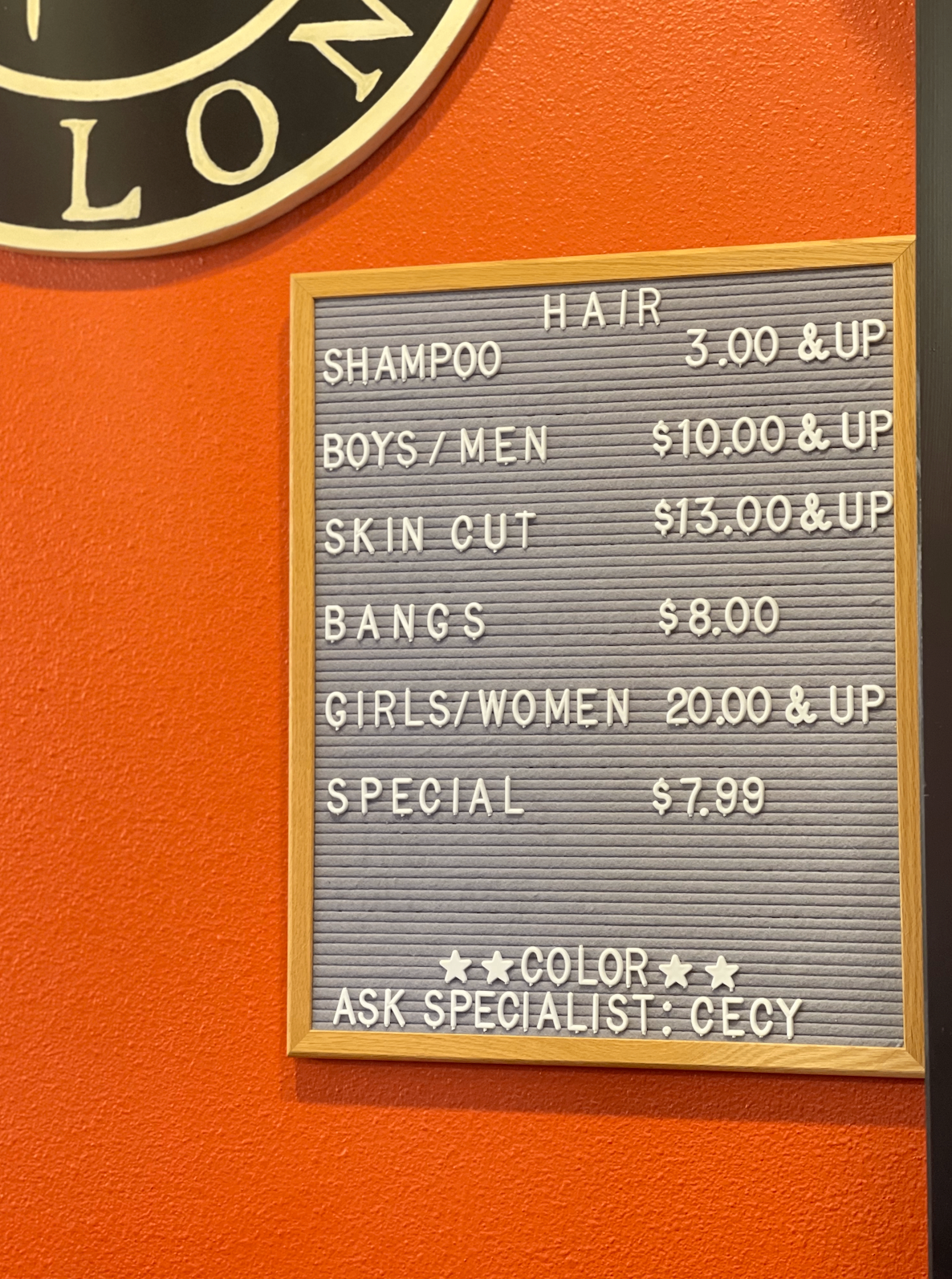 Price board hanging in Cleo's Salon