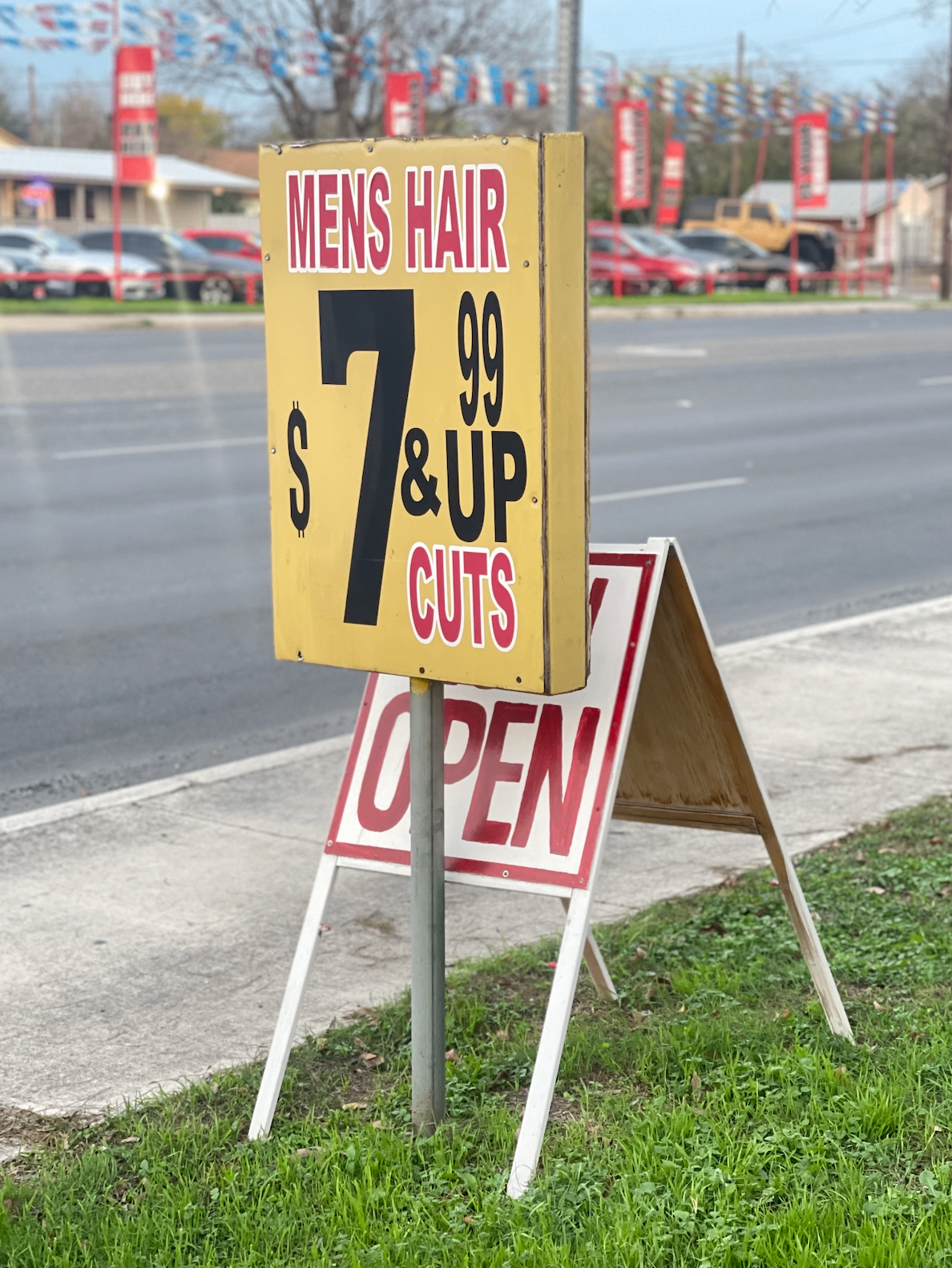 The famous yellow $7.99 Men's Hair sign outside Cleo's Salon on S Zarzamora